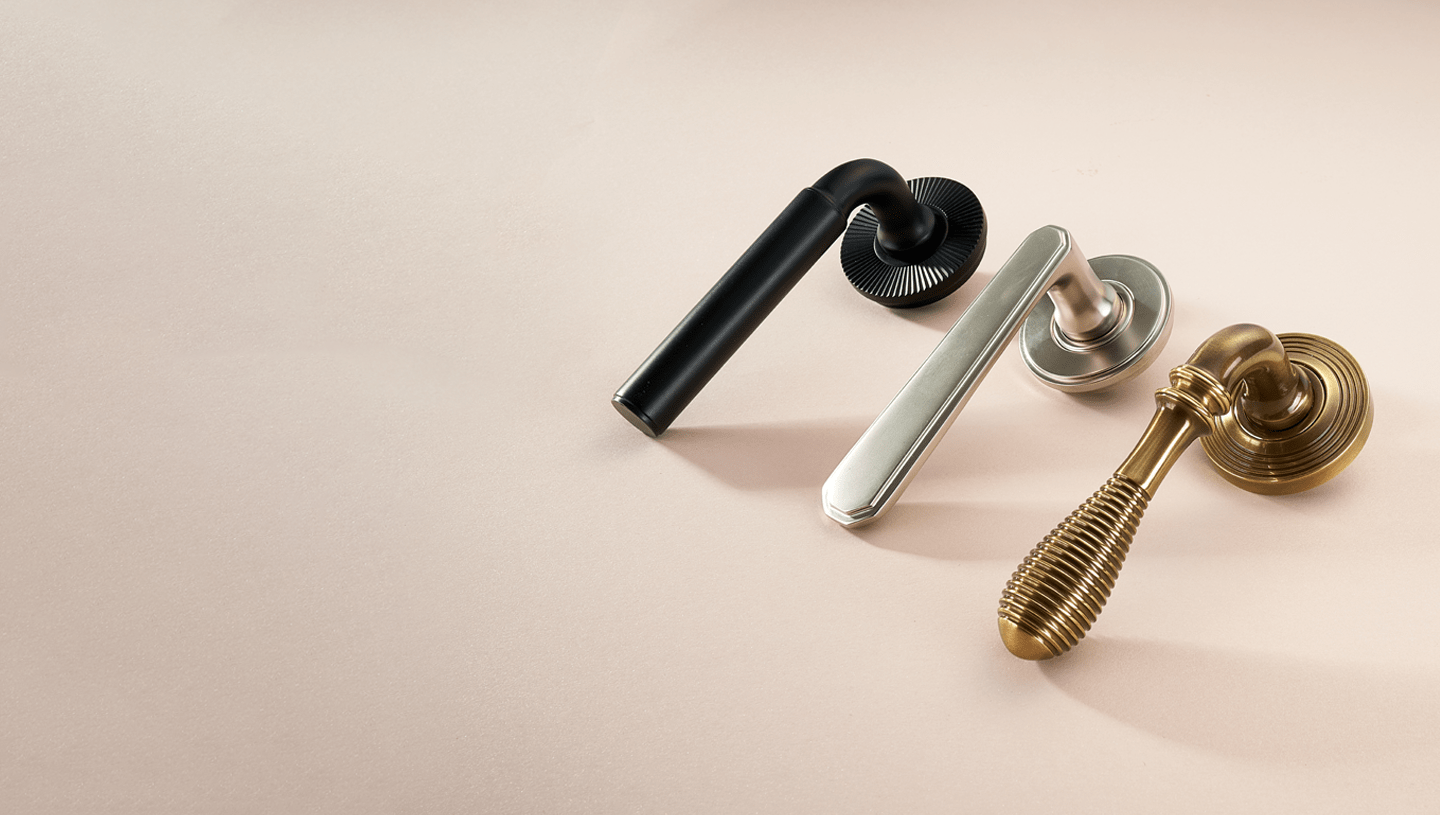 Frank Allart door levers in brass, black, and nickel finishes